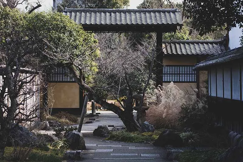 Traditional wooden gate and garden path in Shōsei-en Garden, Kyoto.
